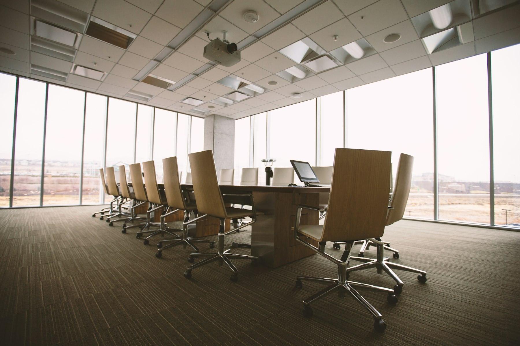 An empty boardroom with a long table